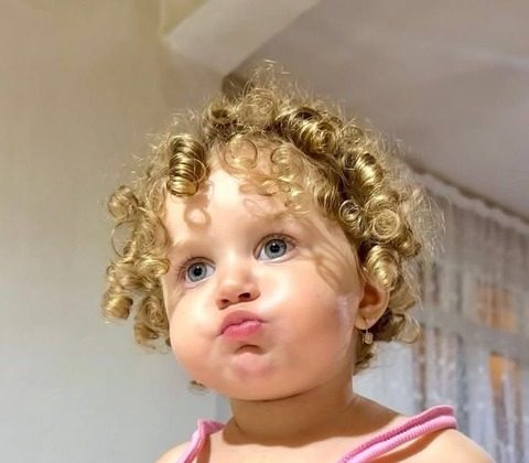 A baby girl with blond curls — original photo