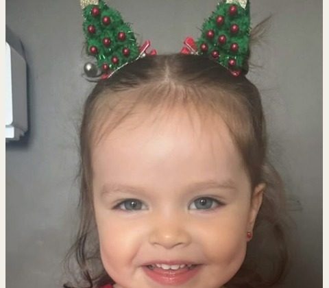 A little girl with a festive headband — original photo